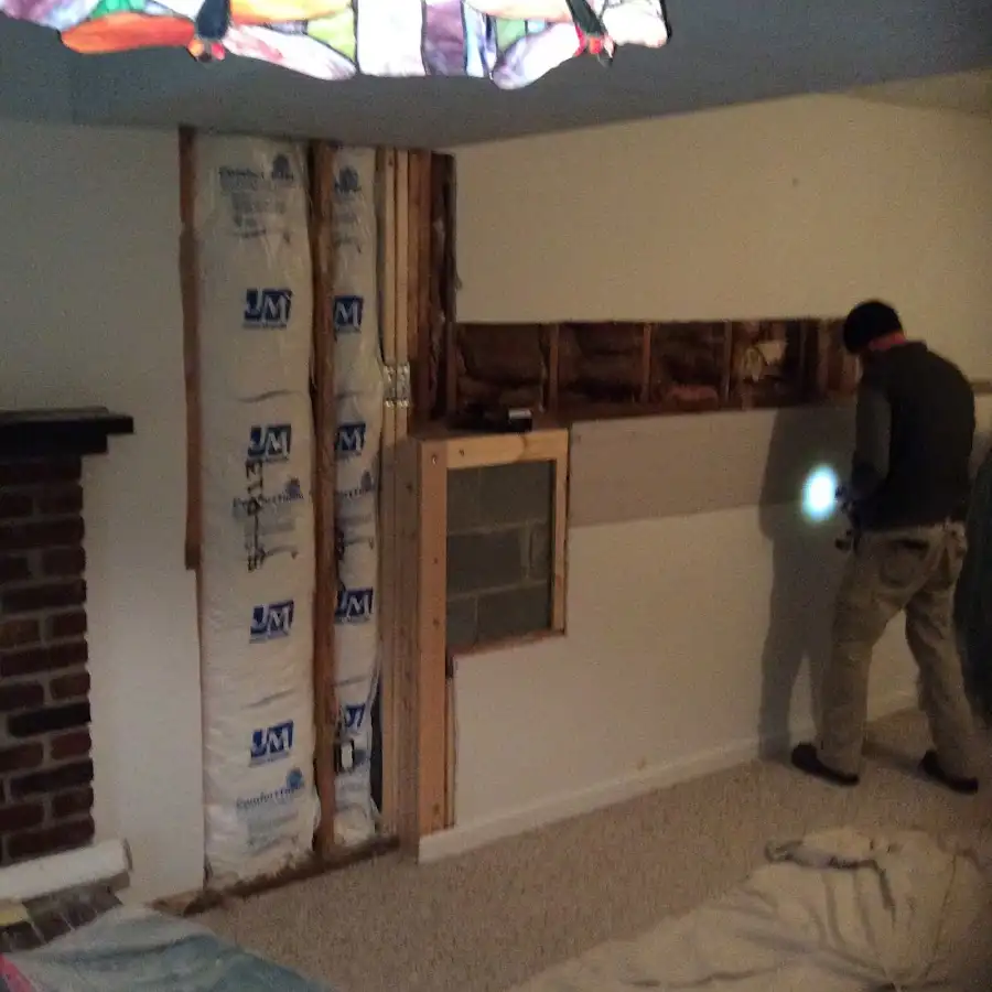 Restoration technician inspecting water damage in Laie